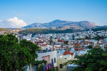 Obraz premium Rethymnon, Crete, Greece - August 15, 2015: view from the fortress of Fortezza to the city of Rethymnon. Roofs of houses and mountains