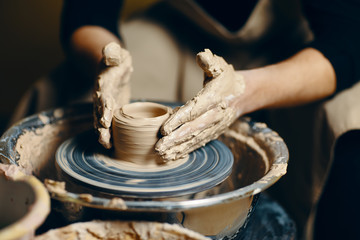 Modeling of clay on a potter's wheel in the pottery workshop - obrazy, fototapety, plakaty