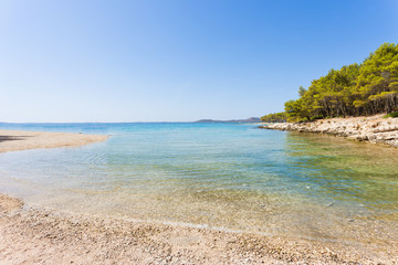 Fototapeta na wymiar Pine beach, Pakostane, Croatia - Calm scenery at the natural beach of Pakostane