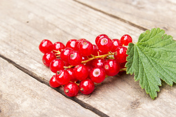 Red currant berries on the board. Summer berry background with place for text. Close-up.