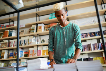 Young student choosing scientific magazine