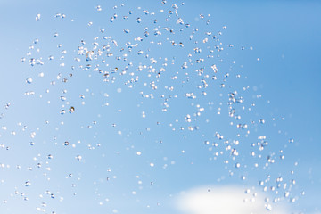 Water drops in the air against the sky