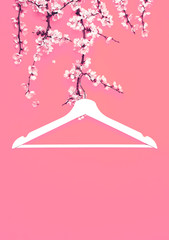 Creative fashion beauty concept. White wooden hanger hanging on the spring flowering branch on pink background. Spring sale concept discount store shopping empty hanger. Flat lay top view copy space.
