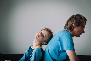 sad child with stressed father, family problems, sorrow