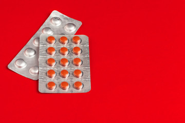 Medical set of Tablets on a red background. Pills