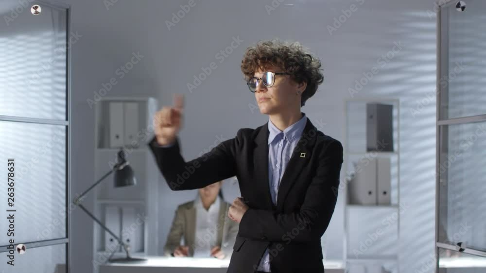 Poster businesswoman in formal suit tapping and swiping on invisible augmented reality screen while her fem