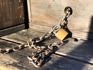 Focus and close up view of brass master key lock and protect rough vintage wooden furniture with...