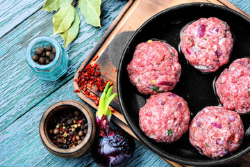 Raw uncooked meatballs