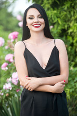 Fototapeta premium Beautiful fashionable girl in rose garden. Series. Gardening.
