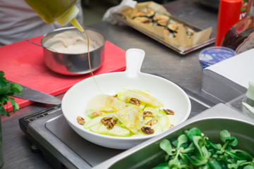 Salad with green apple, walnuts, honey sauce and basil, chef exclusive