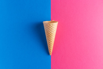 Ice cream cornet over blue and pink background