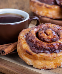 Closeup of a cinnamon roll and cup of coffee
