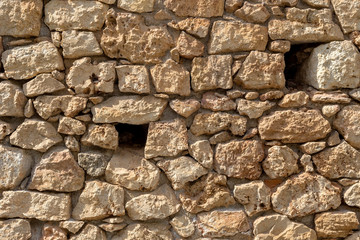 The background old brown stony wall
