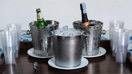Ice bucket with a bottle on the back and a pasted glass