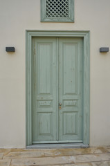 Green wooden door, colorful door in Mediterranean style in Nicosia, Cyprus.  Vintage background. Traditional greek door