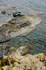 Sea rocks flooded by water on a cloudy winter day.
