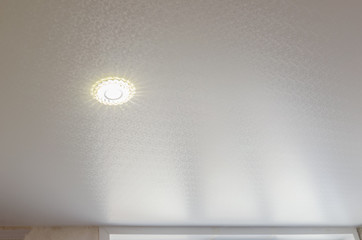 Ceiling in the room with spotlights installed and turned on