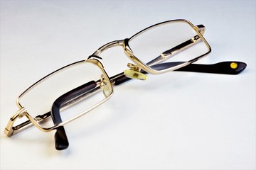Glasses for vision correction on a white background. Glasses are a common optical device designed to improve a person's poor vision.
