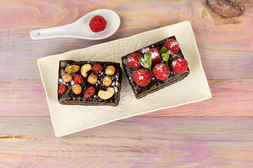 Cakes in a chocolate cover, with raspberry nuts and dried fruits