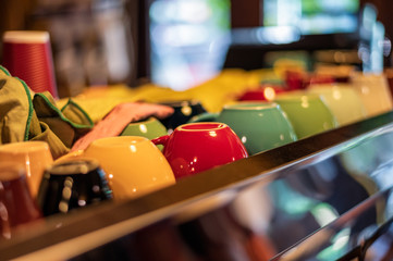 Colors ceramic coffee cup sorted on coffee maker