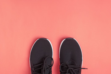 Black sneakers for run or fitness on bright yellow background,