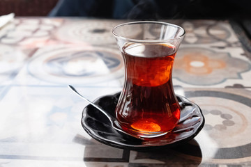 A glass of traditional turkish tea on the table