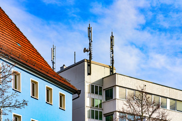 Fototapeta na wymiar Mobile antennas on a house roof