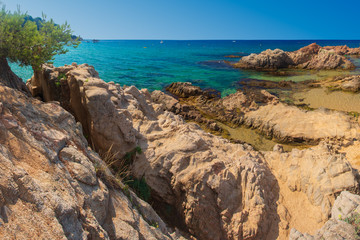 Fototapeta na wymiar Spain beach. Blue summer sea rocky beach in spanish coast