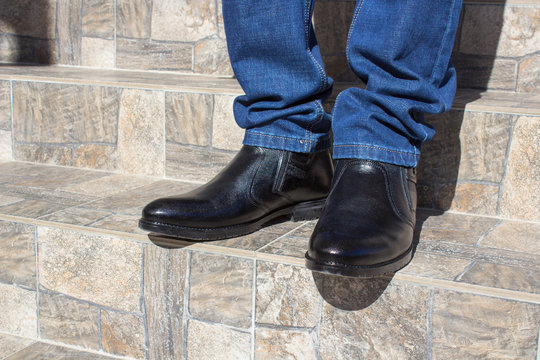 stand in the shoes on the stairs,Close-up of a man in black shoes on the stairs