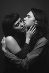 Young man and girl are kissing. Black and white