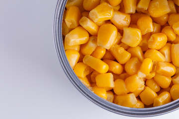 Canned corn in a iron can on white background
