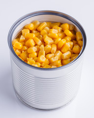Canned corn in a iron can on white background