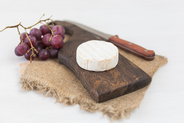 Fototapeta na wymiar Cheese brie with on rustic wooden board