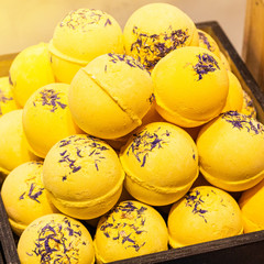 Shop cosmetic handmade bombs and bubble bath different colors. The concept of Spa and relaxation