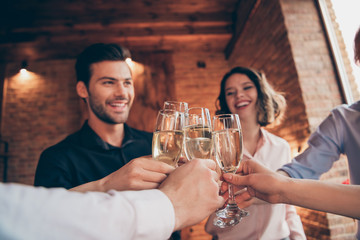 Cropped close-up wineglasses nice winsome lovely attractive pretty cheerful positive guys ladies having fun greetings congrats birthday festal lights merry Christmas in industrial loft interior room