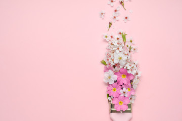 Flowers composition. Paintbrush With Blossoms and pink flowers on pink background. Flat lay, top view, copy space