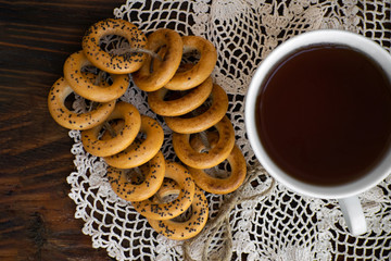 Bagels with cup of tea on a wooden board.