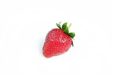 Ripe local produce organic strawberry. Single berry in the middle of shot. Fresh healthy vegan dietary food for spring detox. Fruit background, top view. Clean eating concept.