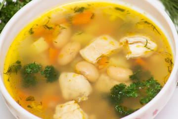 Bean soup with chicken. View from above on a white background