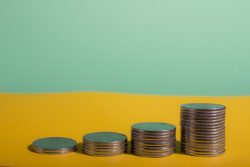 money, coins are shown in ascending order, concept of wealth growth, warm gamma