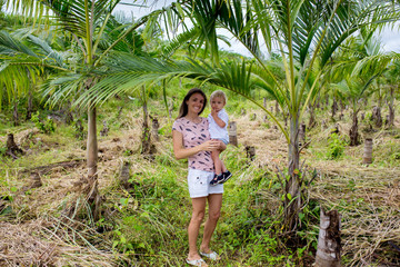 Happy people, children, enjoying field with palm trees on Mauritius island