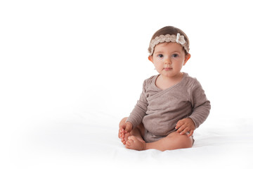 Cute baby girl playing with his legs portrait