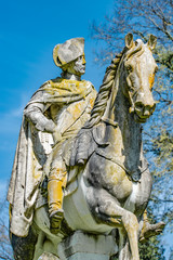 Fototapeta premium Very old statue of Prussian King Frederick the Great covered with moss and lichen, Potsdam, Germany
