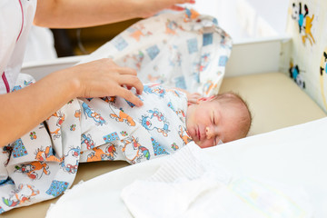 Obraz na płótnie Canvas Newborn baby. Little child in medicine hospital. Medical health care. Doctor pediatrician. Small kid, infant in clinic