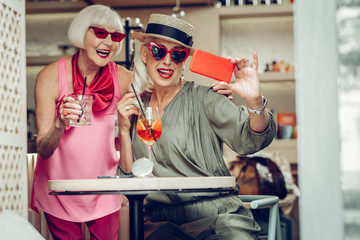 Nice cheerful women sitting in the cafe together