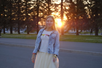 Beautiful girl posing in the streets of city at sunset