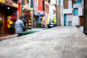 wooden table  and blurred street scene in the background