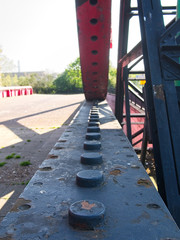 Close-up of the rack and pinion of an old rusty steel lifting bridge.