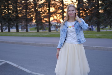 Beautiful girl posing in the streets of city at sunset