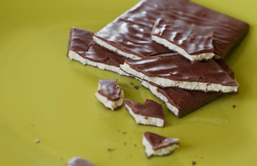  milk chocolate with white coconut filling on a green plate